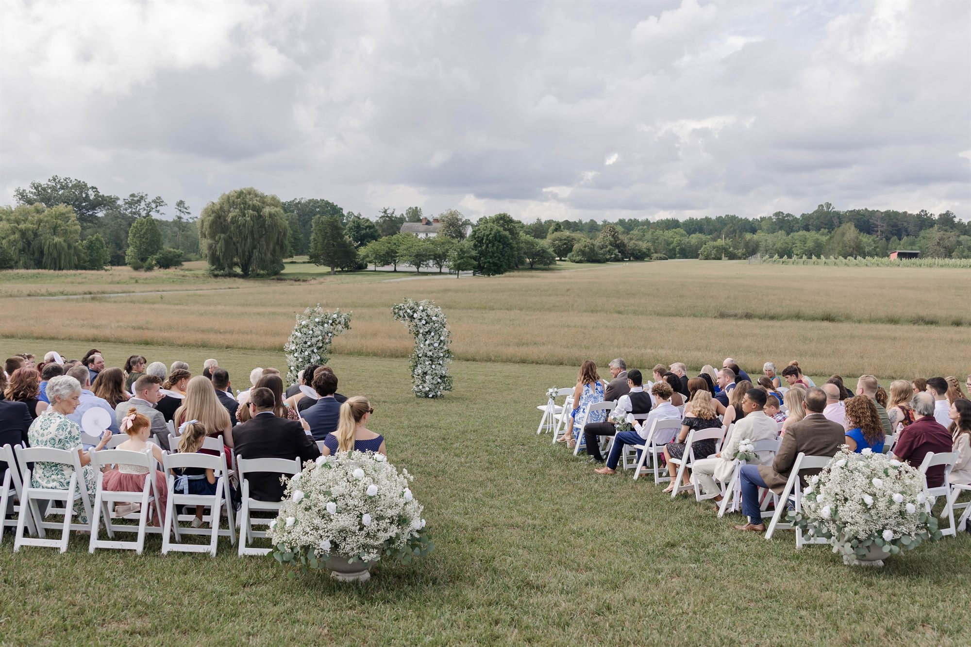 Guests seated for a field ceremony at Whitehall Farm