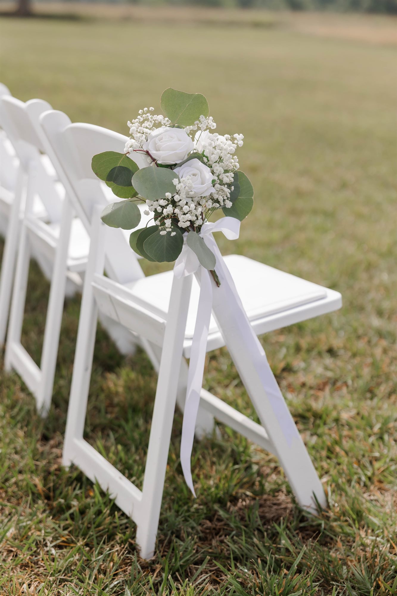 Ceremony chair with a white floral posy