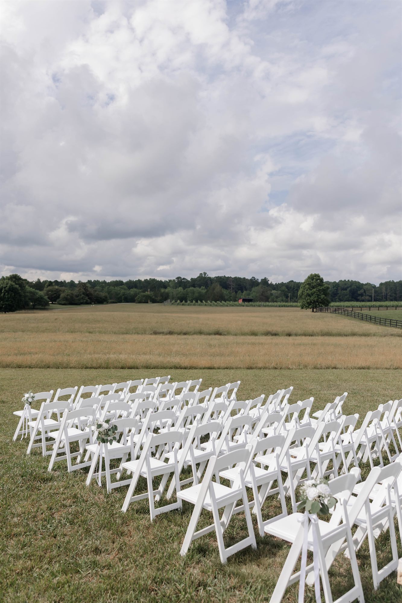 Ceremony chairs set in the field