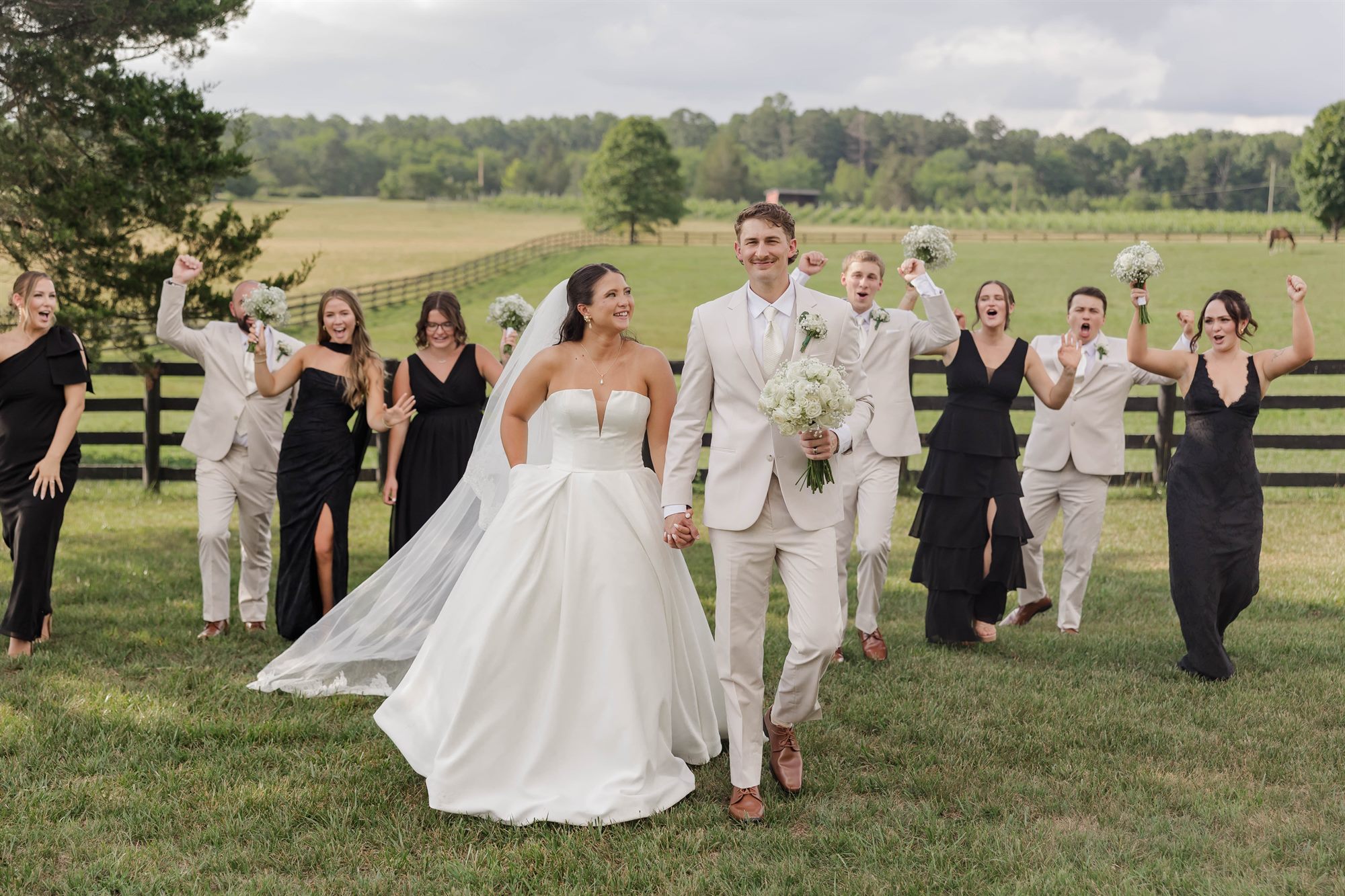 Bridal party celebrating in the pasture