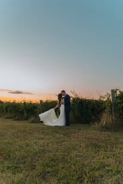 Couple at the edge of the vineyard at sunset